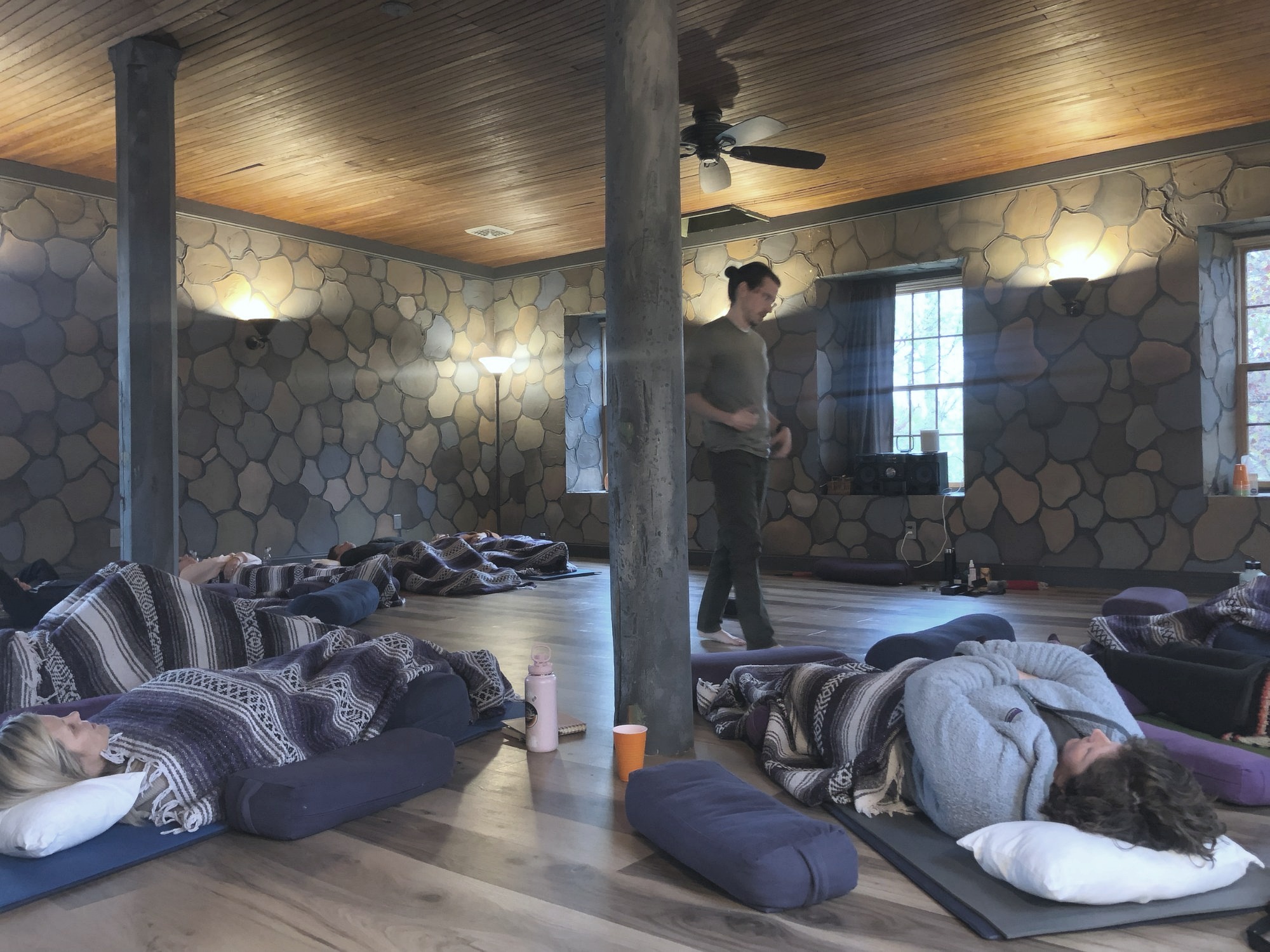 Indoor breathwork session with participants lying on yoga mats